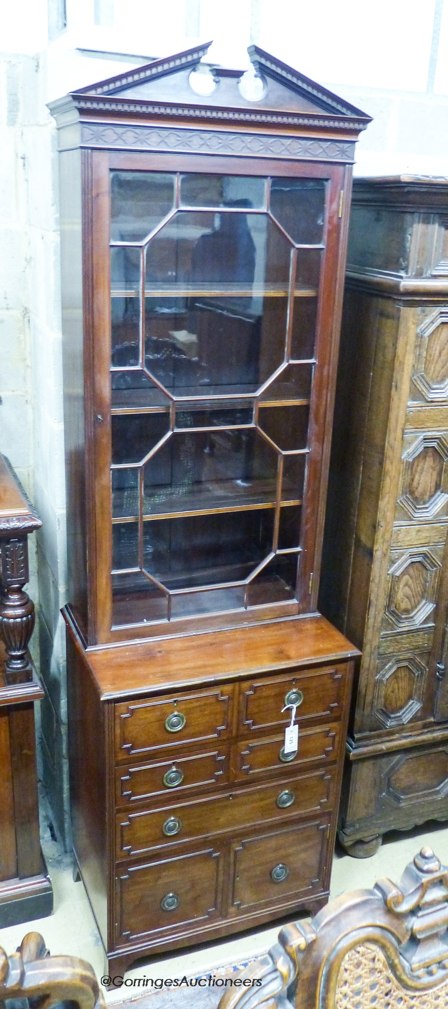 An early 20th century George III style narrow mahogany bookcase on chest, width 65cm, depth 44cm, height 218cm